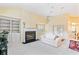 Living room with fireplace, built-in shelving, and French doors to patio at 840 Coach Lamp Ct, Sanford, FL 32771