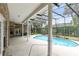 Inviting kidney-shaped pool with screened enclosure and spacious patio at 840 Coach Lamp Ct, Sanford, FL 32771