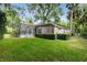 Landscaped backyard with lush lawn and screened pool area at 840 Coach Lamp Ct, Sanford, FL 32771