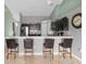 Modern kitchen with dark cabinetry, stainless steel appliances, and a breakfast bar at 617 Brockton Dr, Kissimmee, FL 34758