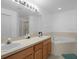 Primary bathroom with double vanity, corner tub, and updated lighting at 617 Brockton Dr, Kissimmee, FL 34758