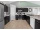 Modern kitchen with dark wood cabinets, stainless steel appliances, and tile flooring at 617 Brockton Dr, Kissimmee, FL 34758