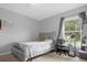 Comfortable bedroom with window and a home office setup at 617 Brockton Dr, Kissimmee, FL 34758