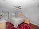 Bright bedroom featuring a double bed, ceiling fan, and hardwood floors at 1001 Via Capri Ln # 204, Celebration, FL 34747