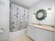 Clean bathroom with tub, shower, vanity, and Paris-themed decor at 1001 Via Capri Ln # 204, Celebration, FL 34747