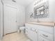 Clean bathroom with white vanity and a decorative mirror at 1001 Via Capri Ln # 204, Celebration, FL 34747