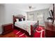 Cozy bedroom with hardwood floors and a wood frame bed at 1001 Via Capri Ln # 204, Celebration, FL 34747