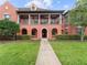 Two-story building with red exterior and a welcoming walkway at 1001 Via Capri Ln # 204, Celebration, FL 34747