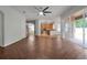 Open living room with herringbone floors and view of kitchen and patio at 10233 Serotina Ct, Orlando, FL 32832