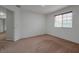 Simple bedroom with carpet, window and access to hallway at 10233 Serotina Ct, Orlando, FL 32832
