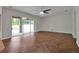 Living room showcasing herringbone wood-look floors and sliding glass doors at 10233 Serotina Ct, Orlando, FL 32832