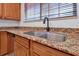Kitchen sink with granite countertop and oil-rubbed bronze faucet at 10233 Serotina Ct, Orlando, FL 32832