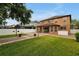 Landscaped backyard with brick pavers and a large lawn area at 10233 Serotina Ct, Orlando, FL 32832