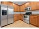 Modern kitchen with stainless steel appliances and wood cabinets at 10233 Serotina Ct, Orlando, FL 32832