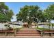 Brick patio and steps leading to a spacious backyard with a large tree and privacy fence at 10233 Serotina Ct, Orlando, FL 32832