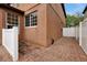 Brick paved side yard with stucco wall and white fence at 10233 Serotina Ct, Orlando, FL 32832