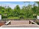 Brick paved patio with wooden benches, lanterns, and lush greenery backdrop at 10233 Serotina Ct, Orlando, FL 32832