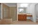 Bathroom with a large glass shower, double vanity, and wood cabinets at 10233 Serotina Ct, Orlando, FL 32832
