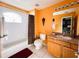 Bathroom with a bathtub, shower, and wood vanity at 1821 Morning Star Dr, Clermont, FL 34714