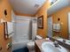 Bright bathroom with tub/shower and wood vanity at 1821 Morning Star Dr, Clermont, FL 34714