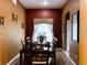 Bright dining room with wood table and chairs, wood floors, and large window at 1821 Morning Star Dr, Clermont, FL 34714