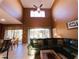 Spacious living room with vaulted ceiling, comfy sectional sofa, and access to a patio at 1821 Morning Star Dr, Clermont, FL 34714