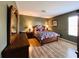 Bedroom with a queen bed, nightstands, and a large mirror at 1821 Morning Star Dr, Clermont, FL 34714