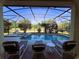 Screened pool and spa with lounge chairs, overlooking a green landscape at 1821 Morning Star Dr, Clermont, FL 34714