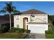 Two-story house with tan exterior, gray roof, and attached garage at 1821 Morning Star Dr, Clermont, FL 34714