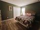 Bedroom with a queen bed, wood furniture, and floral bedding at 1821 Morning Star Dr, Clermont, FL 34714
