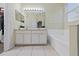 Double vanity and large bathtub in this clean bathroom at 3260 Marshfield Preserve Way, Kissimmee, FL 34746