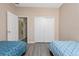 Bright bedroom with twin beds, ample closet space, and light flooring at 3260 Marshfield Preserve Way, Kissimmee, FL 34746