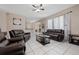 Relaxing living room with brown leather reclining furniture at 3260 Marshfield Preserve Way, Kissimmee, FL 34746