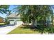 Light green house exterior with 2-car garage and landscaping at 3260 Marshfield Preserve Way, Kissimmee, FL 34746