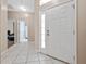 Bright entryway with tile flooring and doors to bedrooms and bathroom at 3260 Marshfield Preserve Way, Kissimmee, FL 34746