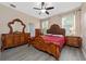 Elegant bedroom with ornate wooden furniture and red bedding at 3260 Marshfield Preserve Way, Kissimmee, FL 34746