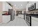 Open concept kitchen with stainless steel appliances and white cabinets at 3260 Marshfield Preserve Way, Kissimmee, FL 34746
