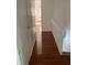 Bright hallway with wood-look laminate flooring and access to other rooms at 2351 Huntington Green Ct # 8, Orlando, FL 32839