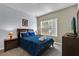 Guest bedroom with a blue comforter, large window, and TV at 2732 Oakwater Dr # 101, Kissimmee, FL 34747