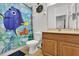bathroom with shower/tub, wood vanity, and Nemo-themed shower curtain at 2732 Oakwater Dr # 101, Kissimmee, FL 34747