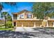 Front view of three-unit townhome building with garages at 2732 Oakwater Dr # 101, Kissimmee, FL 34747