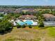 Aerial view of community pool, clubhouse, and surrounding buildings at 2732 Oakwater Dr # 101, Kissimmee, FL 34747