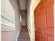 Interior view of a carpeted staircase with a window at 2732 Oakwater Dr # 101, Kissimmee, FL 34747