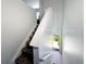 Upstairs view of a carpeted staircase leading down to the entryway at 2732 Oakwater Dr # 101, Kissimmee, FL 34747