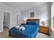 Bedroom with blue comforter, wood nightstands, and access to a closet at 2732 Oakwater Dr # 101, Kissimmee, FL 34747