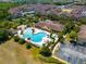 Aerial view showing resort-style pool, clubhouse, and community at 2732 Oakwater Dr # 101, Kissimmee, FL 34747
