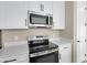 Stainless steel appliances and white cabinets in this modern kitchen at 1472 Erin Breeze Ln, Kissimmee, FL 34744