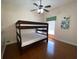 Bedroom with a full-size bunk bed and hardwood floors at 7953 Sea Pearl Cir, Kissimmee, FL 34747
