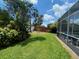 Spacious backyard with a screened enclosure and plenty of green space at 7953 Sea Pearl Cir, Kissimmee, FL 34747