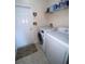 Laundry room with washer, dryer, and built-in shelving at 7953 Sea Pearl Cir, Kissimmee, FL 34747